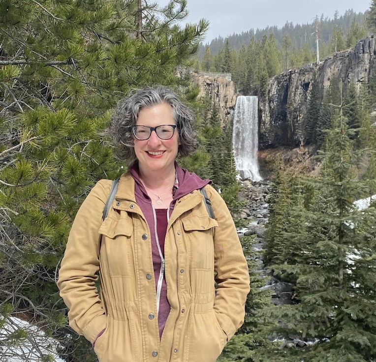 a head shot of Sharon Maier-Kennelly in front of a waterfall in Central Oregon